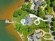 Stunning aerial view of lakefront estate with lush landscaping, circular driveway, pool and private dock at 2477 Peninsula Shores Ct, Denver, NC 28037