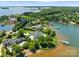 Beautiful lakefront property featuring a large home, manicured lawns, mature trees, and private boat docks at 2477 Peninsula Shores Ct, Denver, NC 28037