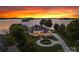 Stunning lakefront estate with lush landscaping, circular drive, and breathtaking sunset views at 2477 Peninsula Shores Ct, Denver, NC 28037