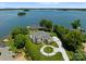Stunning aerial view of the waterfront estate, showcasing the beautifully landscaped grounds and circular driveway at 2477 Peninsula Shores Ct, Denver, NC 28037