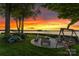 Picturesque backyard featuring outdoor seating area with a fire pit overlooking the tranquil lake at 2477 Peninsula Shores Ct, Denver, NC 28037