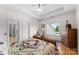 Comfortable bedroom with a wooden bed frame, hardwood floors, and a window overlooking the backyard at 2477 Peninsula Shores Ct, Denver, NC 28037