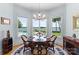 Bright dining area with wood table set, chandelier, and large windows with lake view at 2477 Peninsula Shores Ct, Denver, NC 28037
