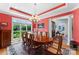 Formal dining room with elegant chandelier, large window, and ample space for entertaining guests at 2477 Peninsula Shores Ct, Denver, NC 28037