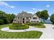 Charming traditional home with meticulous landscaping, circular driveway, and picturesque curb appeal at 2477 Peninsula Shores Ct, Denver, NC 28037