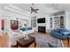 Bright living room with custom built-ins, a fireplace, and large windows for abundant natural light at 2477 Peninsula Shores Ct, Denver, NC 28037
