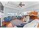 Open-concept living room boasts a fireplace, lake views, and seamless flow to the kitchen at 2477 Peninsula Shores Ct, Denver, NC 28037