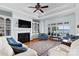 Inviting living room with fireplace, custom shelving, and expansive windows providing breathtaking lake views at 2477 Peninsula Shores Ct, Denver, NC 28037