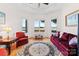 Cozy living room with comfortable seating, hardwood floors, and windows overlooking the lake at 2477 Peninsula Shores Ct, Denver, NC 28037