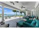 Covered outdoor patio with comfortable seating overlooking the pool and scenic lake views at 2477 Peninsula Shores Ct, Denver, NC 28037