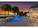 Beautiful pool and spa overlooking the lake, surrounded by lush greenery and lounge chairs at 2477 Peninsula Shores Ct, Denver, NC 28037
