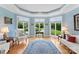 Comfortable sitting area with natural light from large bay windows overlooking a manicured lawn and garden at 2477 Peninsula Shores Ct, Denver, NC 28037