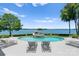 Beautiful swimming pool with an integrated spa, surrounded by lush landscaping and lakefront views at 2477 Peninsula Shores Ct, Denver, NC 28037