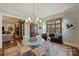 Dining room with decorative chandelier, buffet, and large windows overlooking the backyard at 2544 Portland Ave, Charlotte, NC 28207