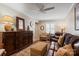 Inviting living room with a ceiling fan, plush leather furniture, and a large decorative cabinet for storage at 2705 North Center St # 6, Hickory, NC 28601