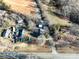Aerial view of a residential property with a road, surrounding vegetation, and neighboring houses at 28419 Nc Hwy 73 Hwy, Albemarle, NC 28001