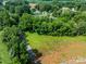 Lush acreage with private drive, open fields, and mature trees provide a secluded, bucolic setting at 28419 Nc Hwy 73 Hwy, Albemarle, NC 28001