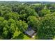 Aerial view showcasing the home nestled amidst lush greenery and mature trees at 28419 Nc Hwy 73 Hwy, Albemarle, NC 28001