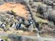 Aerial view of a home with a long driveway, a large yard, and several outbuildings at 28419 Nc Hwy 73 Hwy, Albemarle, NC 28001