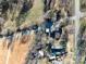 Aerial view of a residential property with a road, surrounding vegetation, and neighboring houses at 28419 Nc Hwy 73 Hwy, Albemarle, NC 28001
