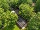 Aerial view of a charming home surrounded by lush greenery and mature trees at 28419 Nc Hwy 73 Hwy, Albemarle, NC 28001