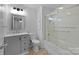Bathroom featuring a tub with glass doors, grey vanity and tile floors at 28419 Nc Hwy 73 Hwy, Albemarle, NC 28001