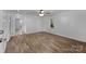 Bedroom featuring wood-look floors, white walls, a ceiling fan, and natural light from a window at 28419 Nc Hwy 73 Hwy, Albemarle, NC 28001