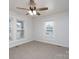 Bright bedroom featuring carpeting, a ceiling fan, and large windows at 28419 Nc Hwy 73 Hwy, Albemarle, NC 28001