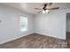 A simple bedroom with wood-look floors, a window, and a neutral color scheme at 28419 Nc Hwy 73 Hwy, Albemarle, NC 28001