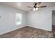 Bedroom with paneled walls, wood look floor, and natural light from window at 28419 Nc Hwy 73 Hwy, Albemarle, NC 28001