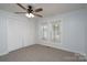 Bright bedroom featuring neutral carpet, ceiling fan, large closet, and natural light at 28419 Nc Hwy 73 Hwy, Albemarle, NC 28001
