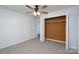 Bright bedroom featuring neutral carpet, ceiling fan, large closet, and a white door at 28419 Nc Hwy 73 Hwy, Albemarle, NC 28001