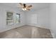 Bedroom featuring carpet, neutral wall color, two windows and ceiling fan at 28419 Nc Hwy 73 Hwy, Albemarle, NC 28001