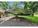 Metal carport sits next to brick fireplace on gravel base in back of property at 28419 Nc Hwy 73 Hwy, Albemarle, NC 28001