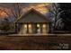 Charming single-story home with covered front porch and warm light glowing through the windows at dusk at 28419 Nc Hwy 73 Hwy, Albemarle, NC 28001