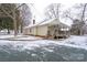 Quaint one-story home with a welcoming front porch and a red brick foundation, surrounded by a snowy landscape at 28419 Nc Hwy 73 Hwy, Albemarle, NC 28001