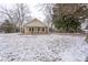Quaint single-story home featuring a covered front porch and snow-covered front yard at 28419 Nc Hwy 73 Hwy, Albemarle, NC 28001