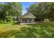Charming single-story home featuring a welcoming front porch, manicured lawn, and mature trees at 28419 Nc Hwy 73 Hwy, Albemarle, NC 28001