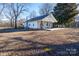 Single-story home with a classic design and large lawn, enhanced by mature trees and a well-maintained yard at 28419 Nc Hwy 73 Hwy, Albemarle, NC 28001