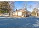 Charming home with a cozy porch, surrounded by mature trees and a gravel driveway, offering a serene setting at 28419 Nc Hwy 73 Hwy, Albemarle, NC 28001