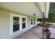 A well lit covered front porch with detailed front door at 28419 Nc Hwy 73 Hwy, Albemarle, NC 28001