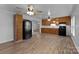The eat-in kitchen showcases wood cabinets, stainless steel sink, and black appliances at 28419 Nc Hwy 73 Hwy, Albemarle, NC 28001