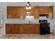 Well-lit kitchen with wood cabinets, white subway tile backsplash, and modern appliances at 28419 Nc Hwy 73 Hwy, Albemarle, NC 28001