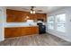 A kitchen featuring wood cabinets, black appliances, and wood floors at 28419 Nc Hwy 73 Hwy, Albemarle, NC 28001