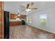 Eat-in kitchen featuring wood cabinets, ceiling fans, white backsplash, and wood-look floors at 28419 Nc Hwy 73 Hwy, Albemarle, NC 28001