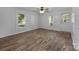 Living room showcasing wood-look floors, natural light from the windows, and an exterior door at 28419 Nc Hwy 73 Hwy, Albemarle, NC 28001