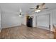 Open-concept living area featuring wood-look floors, ceiling fans, and white painted walls at 28419 Nc Hwy 73 Hwy, Albemarle, NC 28001