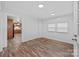 Bright living room with wood-look flooring, white walls, and lots of natural light from large windows at 28419 Nc Hwy 73 Hwy, Albemarle, NC 28001