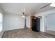 Bright living room featuring wood-look flooring, a ceiling fan, and black refrigerator at 28419 Nc Hwy 73 Hwy, Albemarle, NC 28001