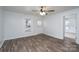 Inviting living room with wood-look floors, a ceiling fan, and abundant natural light at 28419 Nc Hwy 73 Hwy, Albemarle, NC 28001